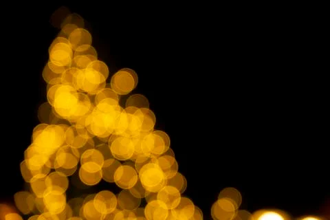 Defocused of blurred golden bokeh circle light from lighting bulb Stock Photos
