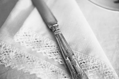 Defocused, blurred, grainy, black and white background with vintage knife on Stock Photos