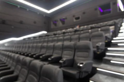 Defocused blurred image of empty black leather seats at movie theater Fotos Stock