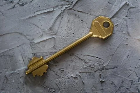 Defocused blurred view of Key on gray Concrete Background. Concept Estate wit Stock Photos