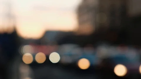 Defocused blurry car lights passing by in traffic jam, sunset on background Stock Footage 101438163