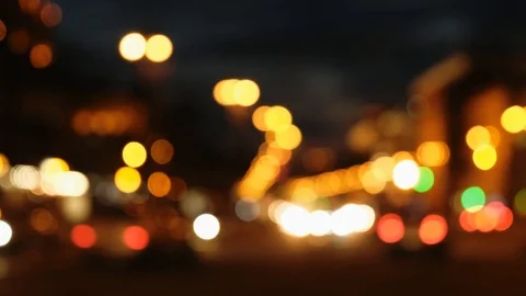 Defocused blurry street car lights passing by in traffic jam late at night Видео 101469879