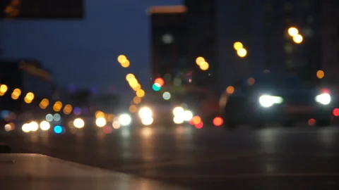 Defocused blurry street car lights passing by in traffic jam late at night Video stock 166380257