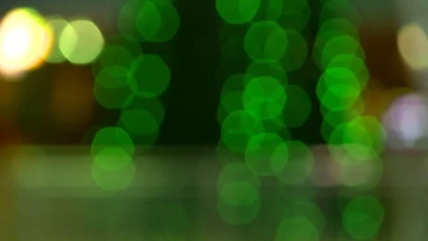 Defocused bokeh Christmas lights blinking on a Christmas tree. Green lights. Video stock 83549950