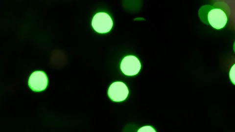 Defocused bokeh Christmas lights blinking on a Christmas tree. Green lights. Stock-Footage 83550474
