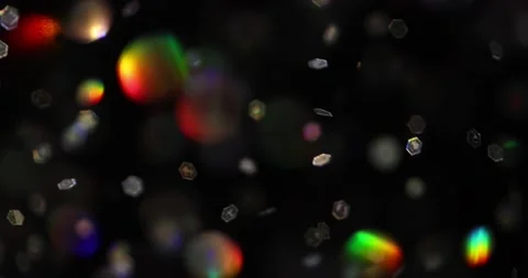 Defocused bokeh colored particles inside a glass Christmas ball.	 Video stock 168181395