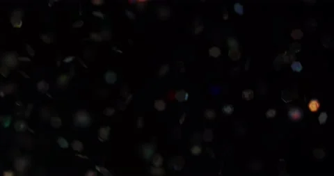 Defocused bokeh colored particles inside a glass Christmas ball.	 Video stock 168181598