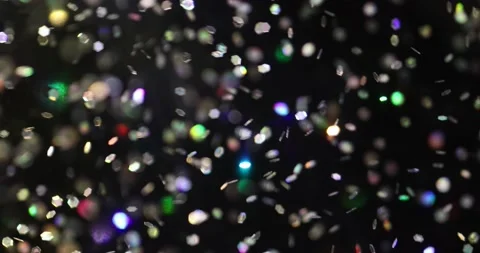 Defocused bokeh colored particles inside a glass Christmas ball.	 Video stock 168181633