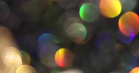Defocused bokeh colored particles inside a glass Christmas ball.	 Video stock 168181665