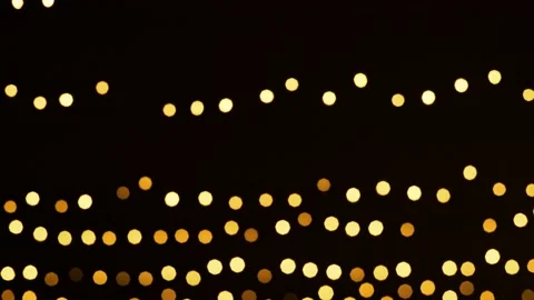 Defocused bokeh effect of garland lights blinking on Black Background Stock Footage 144568257