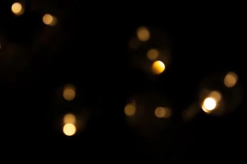 Defocused bokeh lights on black background, an abstract naturally blurred Stock Photos