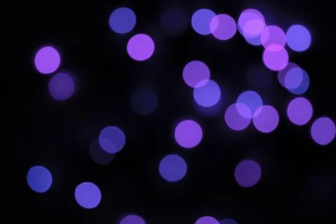 Defocused bokeh lights on black background, an abstract naturally blurred Stock Photos