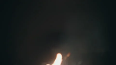 Defocused campfire flames glowing against dark night sky in Sahara Morocco 库存影片 334793135