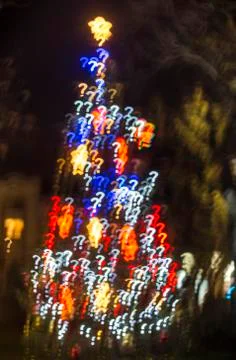 Defocused Christmas tree with question mark shaped bokeh lights Stock Photos