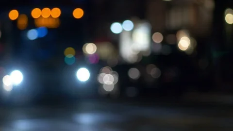 Defocused city traffic at night with an approaching mass transit bus Stock Footage 91324535