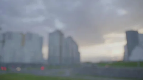 Defocused cityscape covered with large layer of clouds on evening sky Stock Footage 302227924