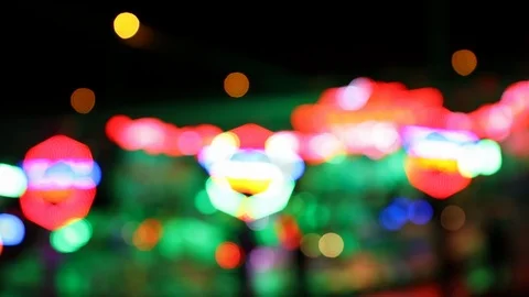 Defocused colorful blinking lights of a carousel ride at night Video stock 124523869