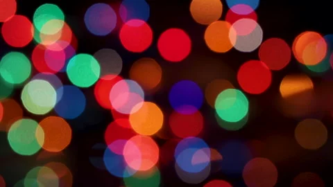 Defocused colorful Christmas lights, blinking bokeh effect, black background. Stock Footage