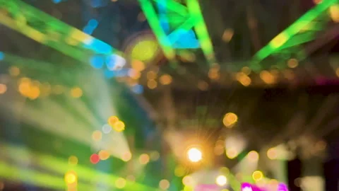 Defocused concert head beam lights create colorful background plate Stock Footage 328953229
