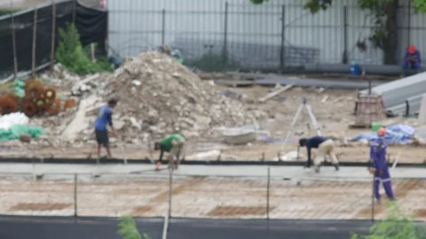 Defocused Construction Workers Pouring and Finishing Concrete Floor Stock Footage 340380729