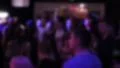 Defocused crowd of young people dancing to DJ music at nightclub HD Footage