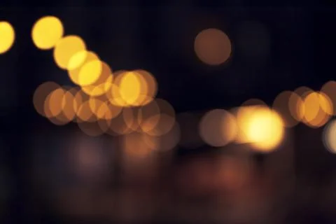Defocused decorative lights form a diagonal flow of warm bokeh circles agai.. Stock Photos