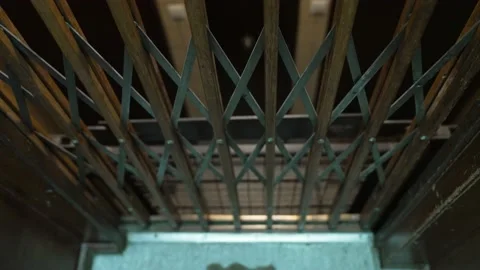 Defocused descending antique elevator. Going down while seeing several Stock Footage 160091287