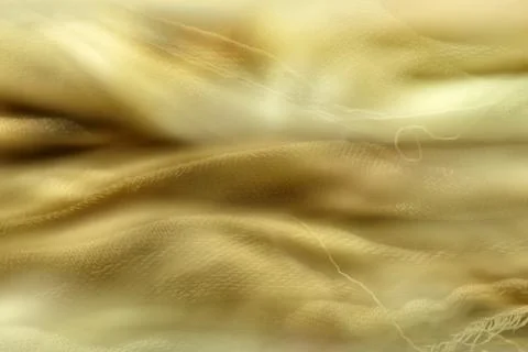 Defocused fabric texture in pastel yellow wrinkled fabric for background Stock Photos