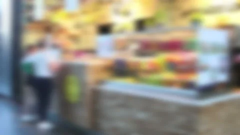 Defocused food vendor stall inside a mall with food display and customers Stock Footage 169102091