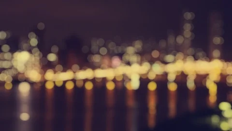 A defocused generic waterside city with glowing bokeh Vídeos de archivo 107483291