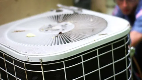 Defocused HVAC technician operating on broken air conditioner unit Video stock 75871403