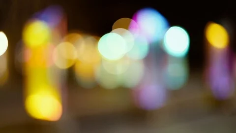 Defocused image of illuminated lights at night Stock Footage 99499386