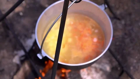 Defocused image of pot cooking on a fire. Tourist trip. Camping Stock Footage 219993760