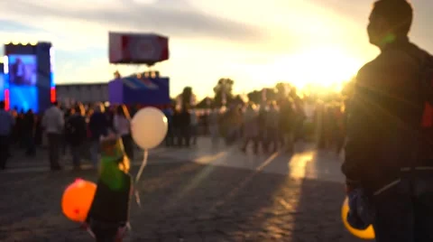 Defocused kid playing with air balloons at sunset. Warm colors. 4K background Stock Footage