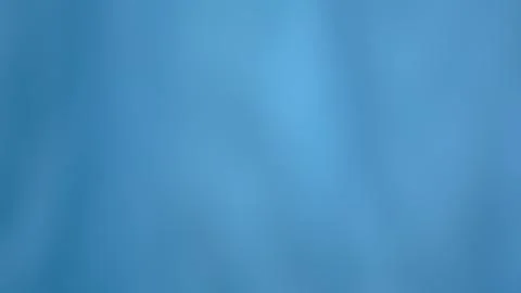 Defocused light blue cloth texture as a background Stock Photos