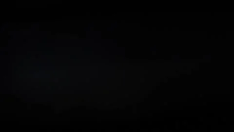 Defocused light glare from incandescent lamp on black background HD Stock Footage 123014868