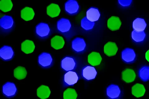 Defocused light of multi-colored light bulbs at night Stock Photos