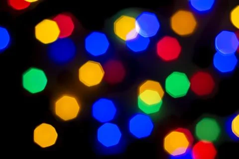 Defocused light of multi-colored light bulbs at night Stock Photos