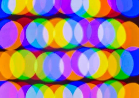 Defocused light of multi-colored light bulbs at night Stock Photos