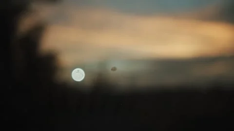 Defocused Light Orb and Soft Colored Sky at Dusk in Outdoor Scene Stock Footage 340839995