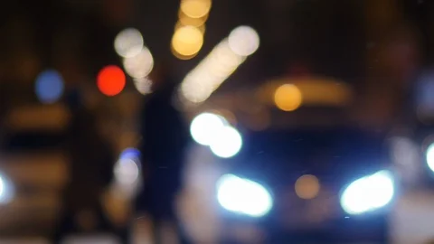 Defocused light of traffic in city at night in wintertime Video stock 127591814
