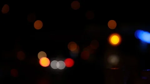Defocused lights of traffic lights and vehicles at night Stock Footage 120138499