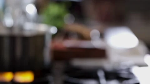  A defocused medium shot of a Asian stainless steel pot on a stove in slow motio Stock Footage 146250208