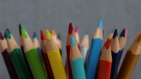 Defocused multi colored pencils on grey background.  Stock Footage 124633913
