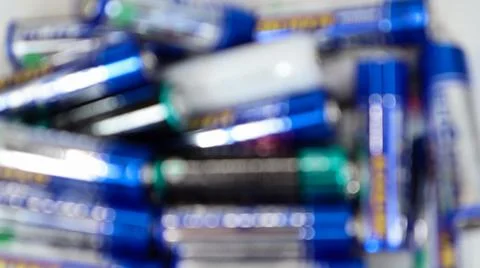 Defocused multicolored random batteries on a AA table, top view. Stock-Fotos