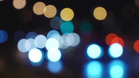 Defocused night city bokeh traffic lights handheld footage with slight movement. Stock Footage