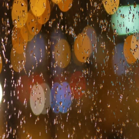 Defocused night traffic lights Through the glass in drops of rain. blur Video stock 69383900