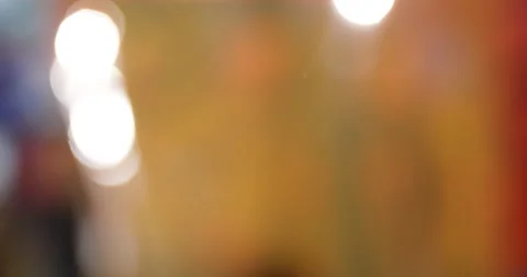 Defocused orange plastic curtain  and moving people in slow motion Stock Footage 130475657