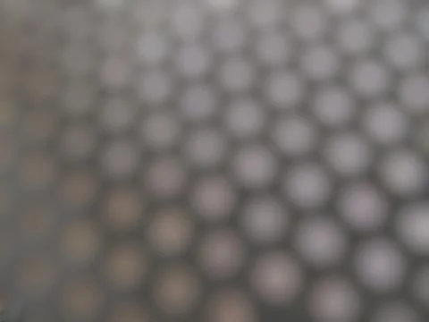 A defocused pattern comprised of rows of circular shapes or dots Stock Photos