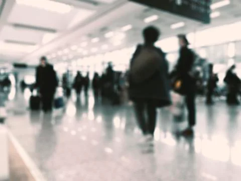 Defocused People waiting in a queue  in front of a gate at the airport. Stock Photos